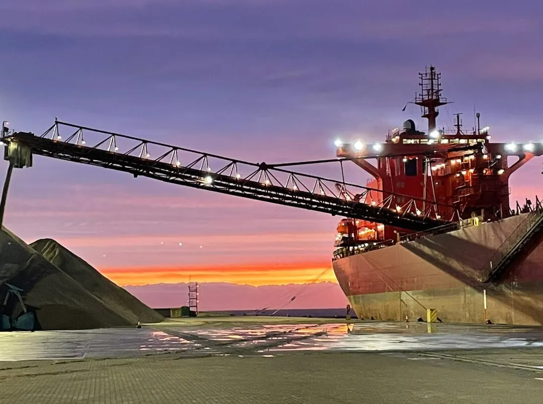 The MV Yeoman Bridge dispensing aggregates delivered by sea to a portside wharf