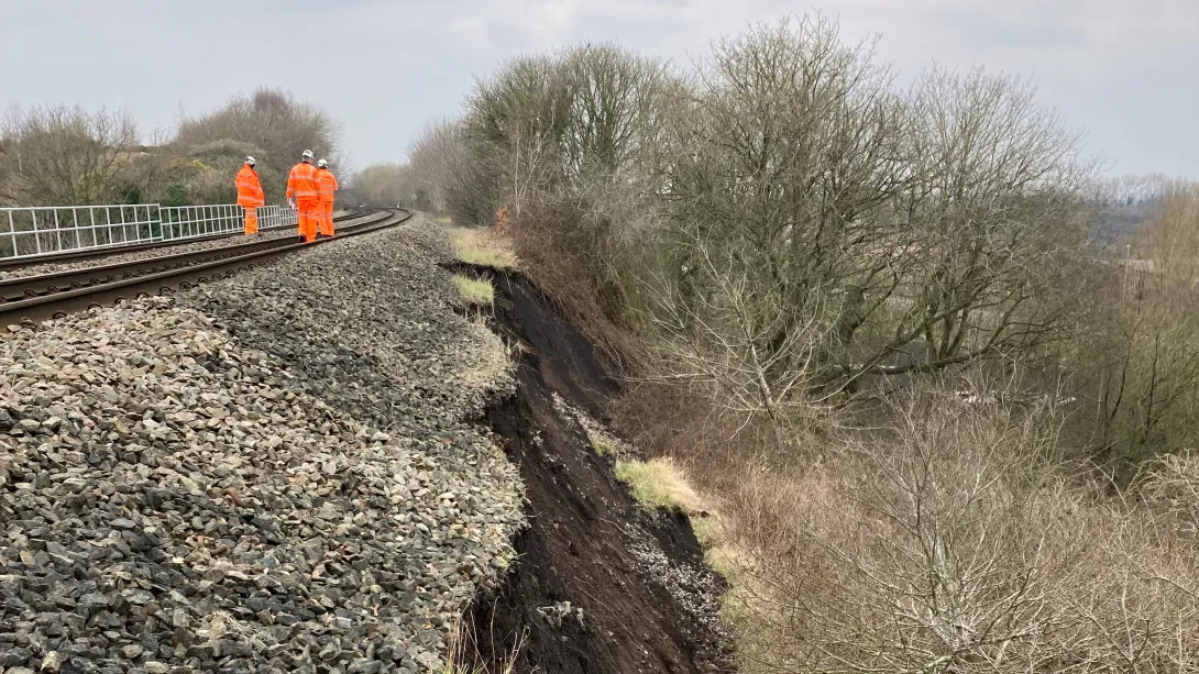 Network Rail engineers inspect a landslip alongside the rail line near Oakengates