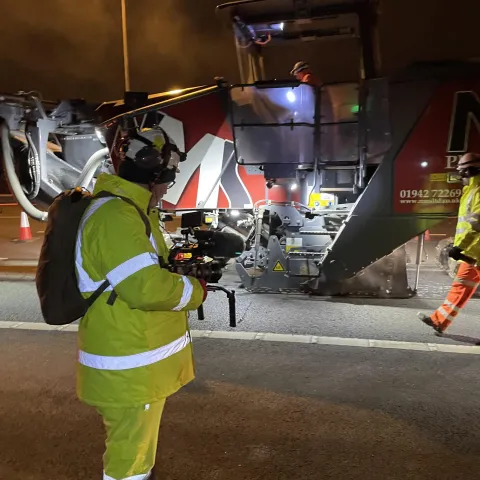 A camera crew from Fearless TV filing for The Motorway look on as Aggregate Industries resurface the M62