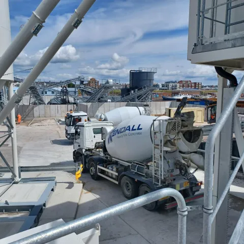 Mixer trucks wait to be loaded at Shoreham readymix concrete plant