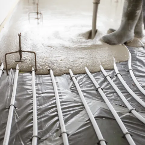 Cemfloor screed being poured over underfloor heating